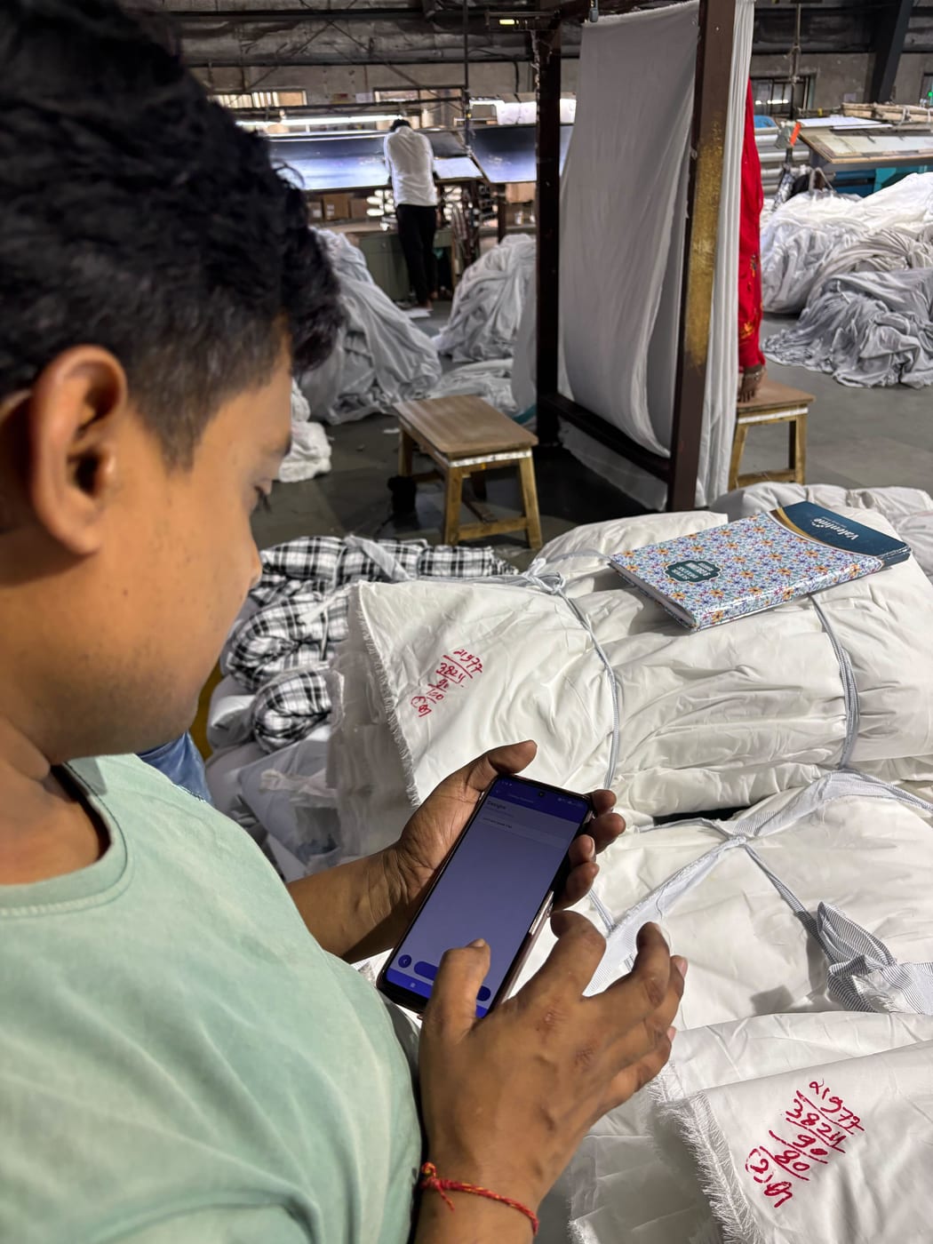 The MobiOffice ERP mobile app in use on a weaving floor